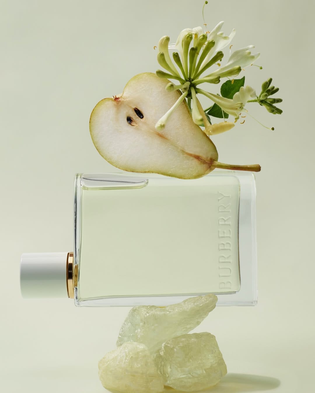 Burberry Her fragrance product photo: clear glass, white cap and pale pear green, glass, soft light, image 1 of 3