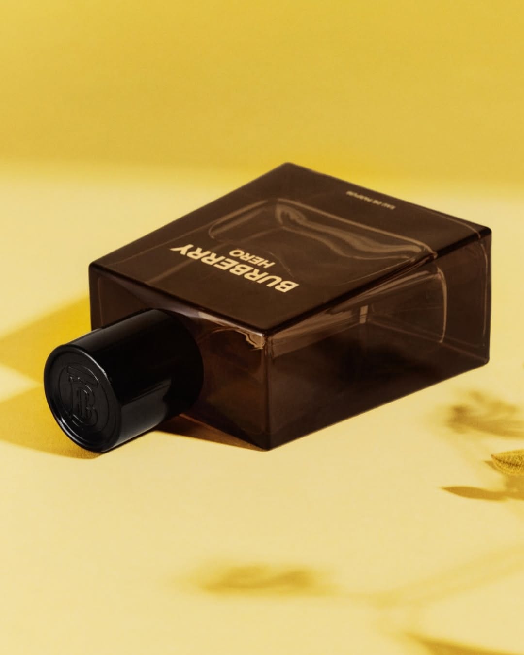 Burberry Hero product photo: smoked amber and black, glass, soft light