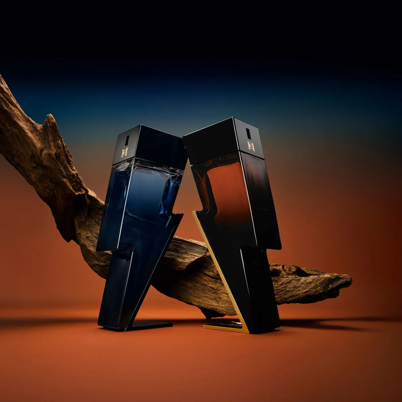 Carolina Herrera Bad Boy product photo: onyx black, burnt orange, navy blue and gold, glass, dramatic light, image 1 of 4