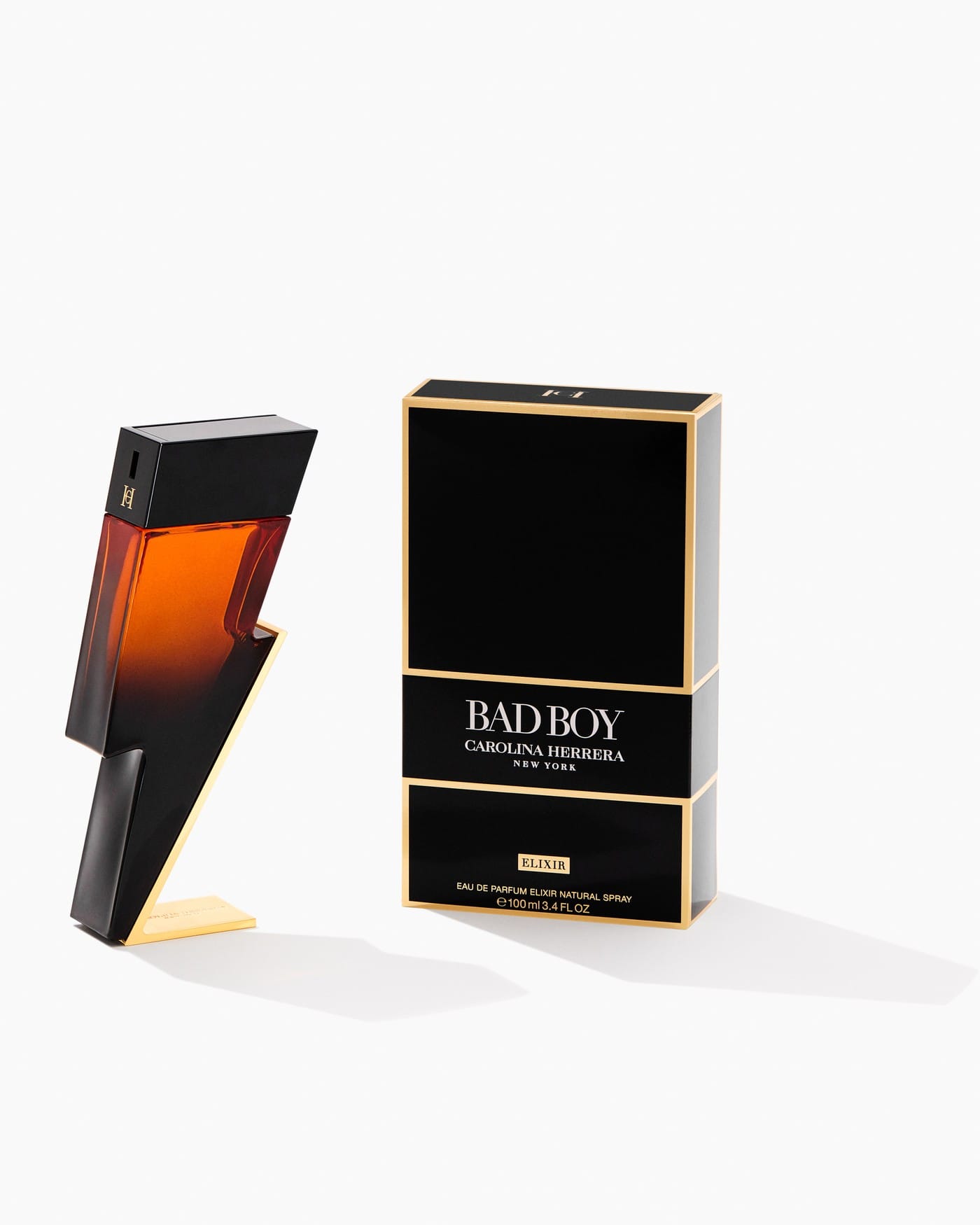 Carolina Herrera Bad Boy product photo: onyx black, burnt orange, navy blue and gold, glass, dramatic light, image 2 of 4