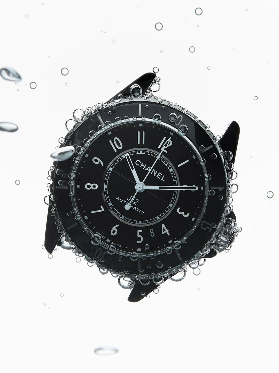 Chanel J12 product photo: black ceramic, steel silver and white dial, metal, soft light