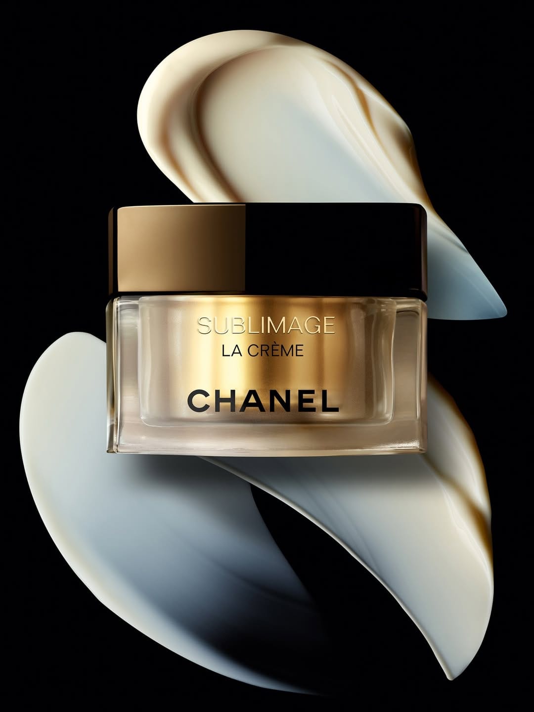 Chanel Sublimage product photo: champagne gold, black cap and cream white, glass, dramatic light, image 1 of 2