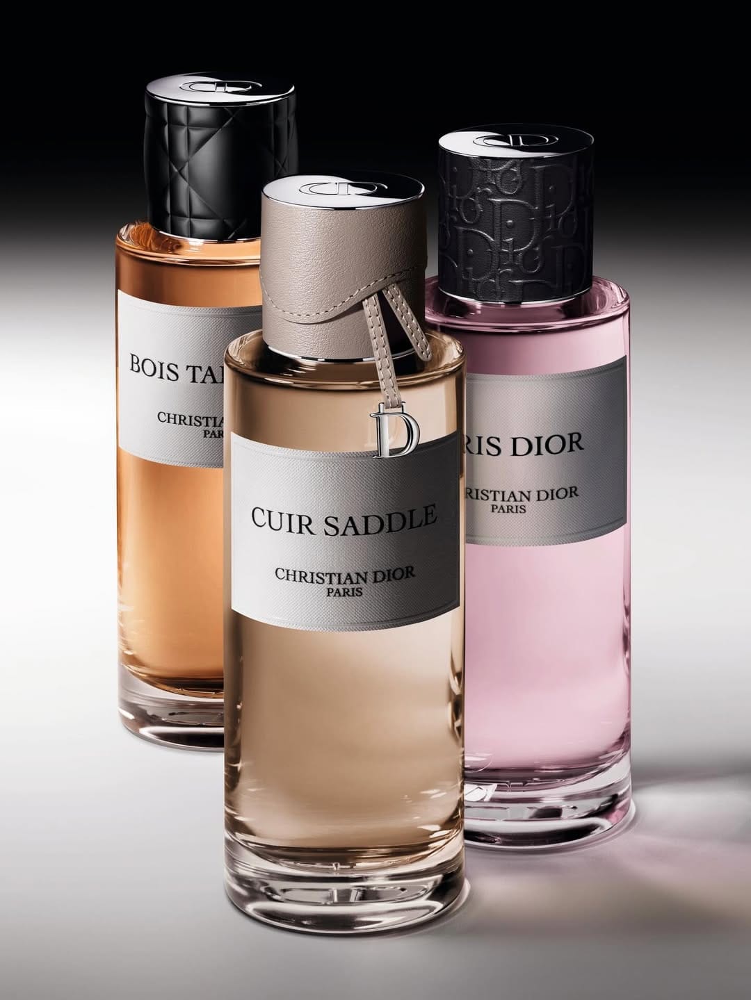 Dior's couture perfume caps product photo: amber beige, taupe leather, blush pink and black, metal, studio light, image 2 of 2