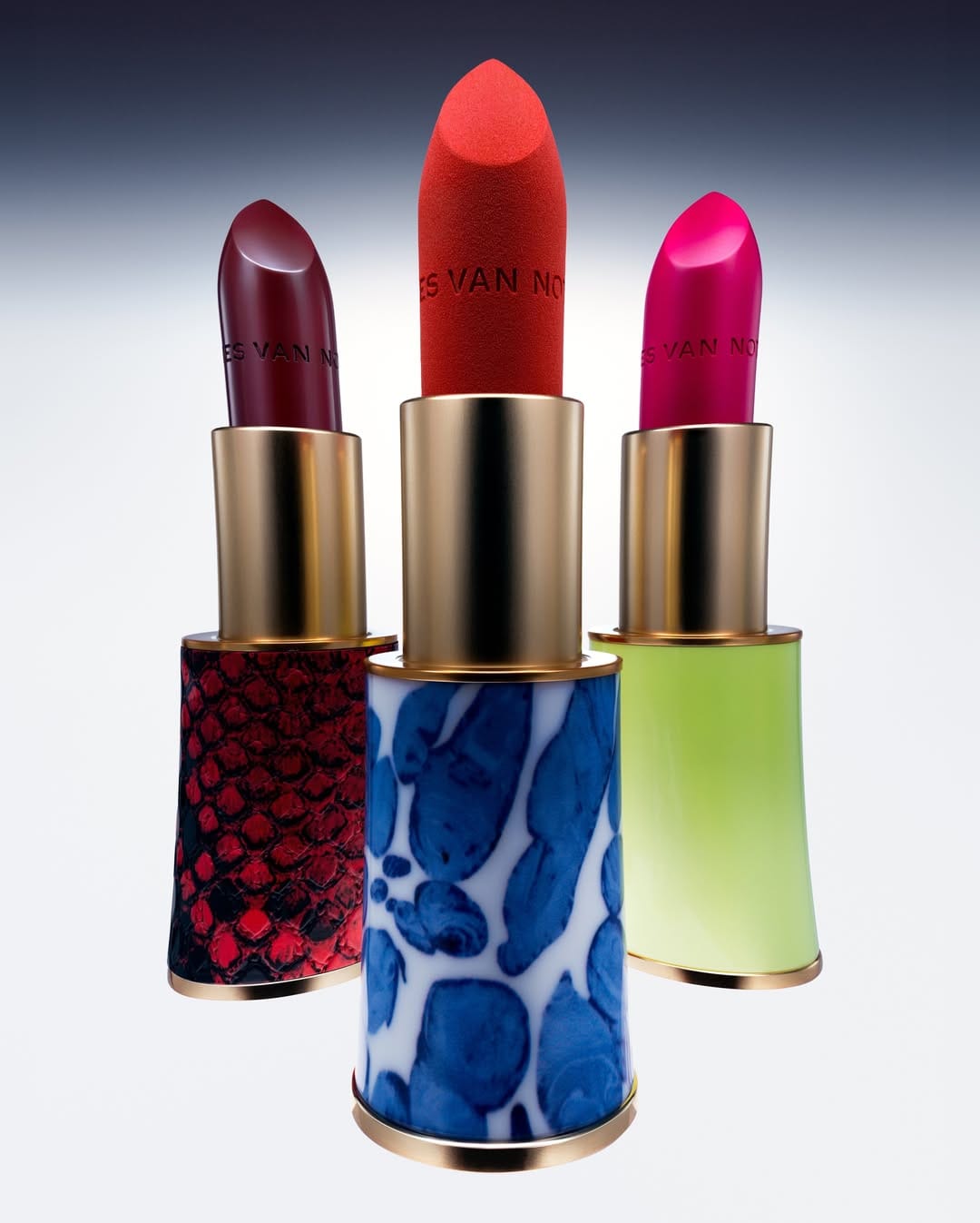 Dries Van Noten lipstick product photo: lipstick red, burnished gold and magenta berry, metal, studio light