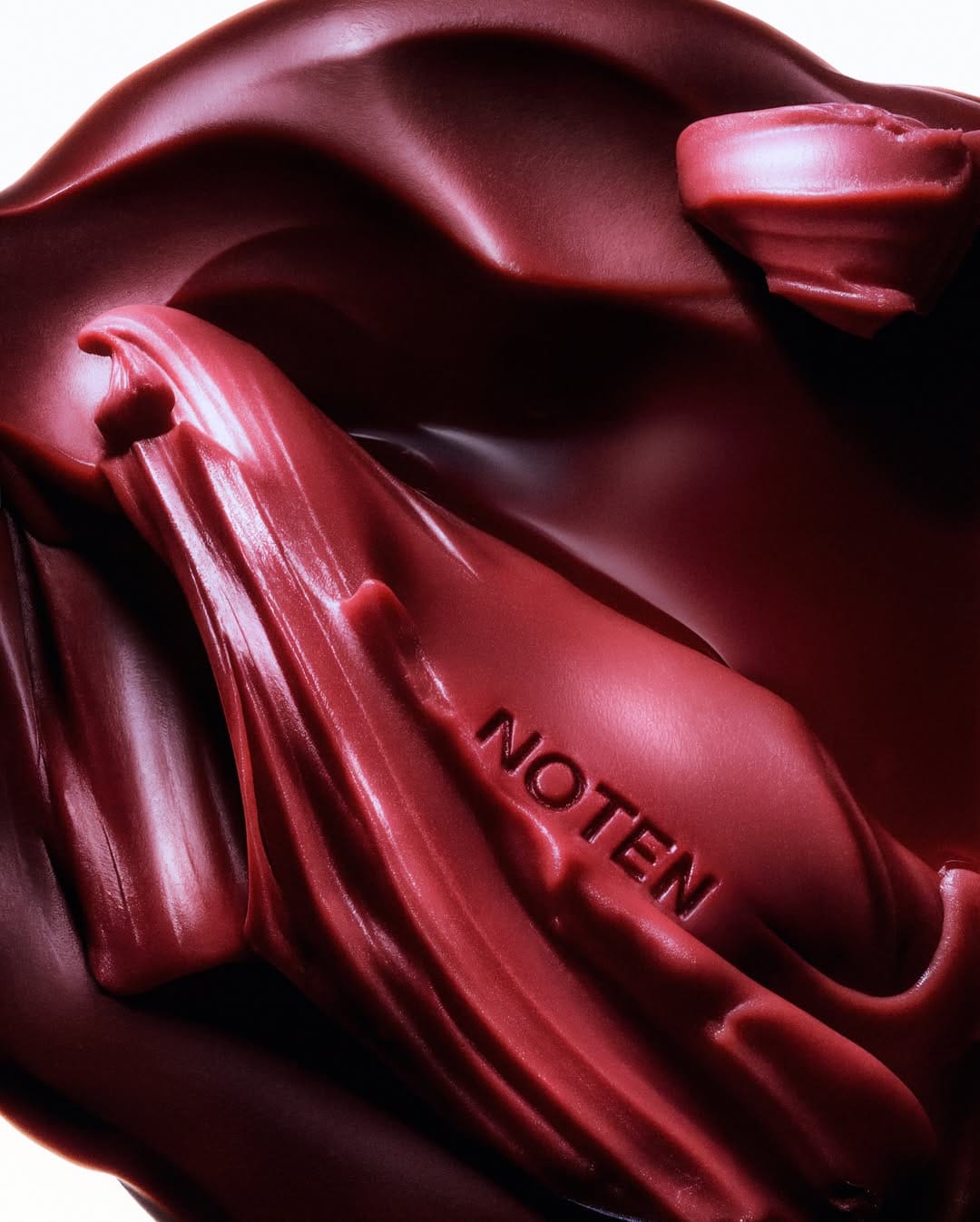 Dries Van Noten lipstick product photo: lipstick red, burnished gold and magenta berry, metal, studio light, image 5 of 6