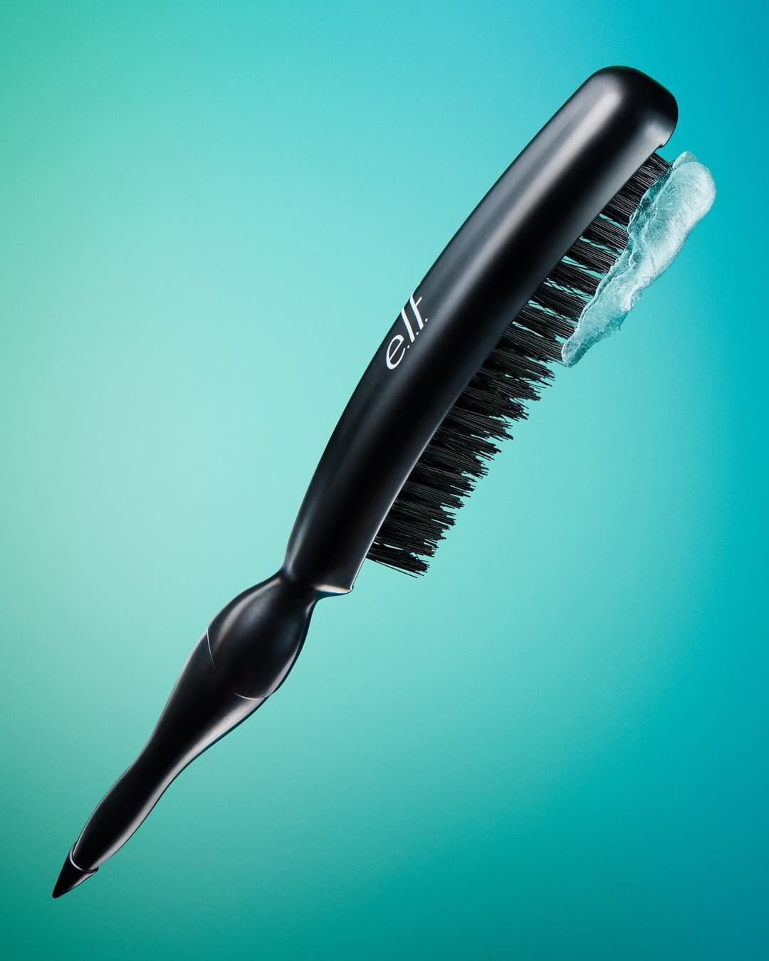 e.l.f. Cosmetics haircare product photo: black and teal, plastic, studio light, image 2 of 3