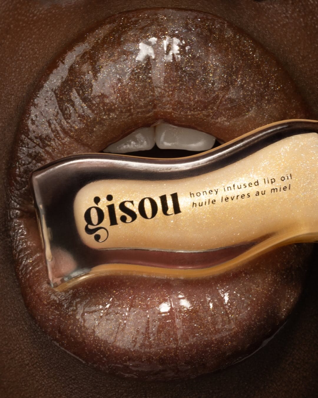 Gisou Tropical Honey Lip Oils product photo: cocoa brown, honey gold and clear glass, glass, soft light