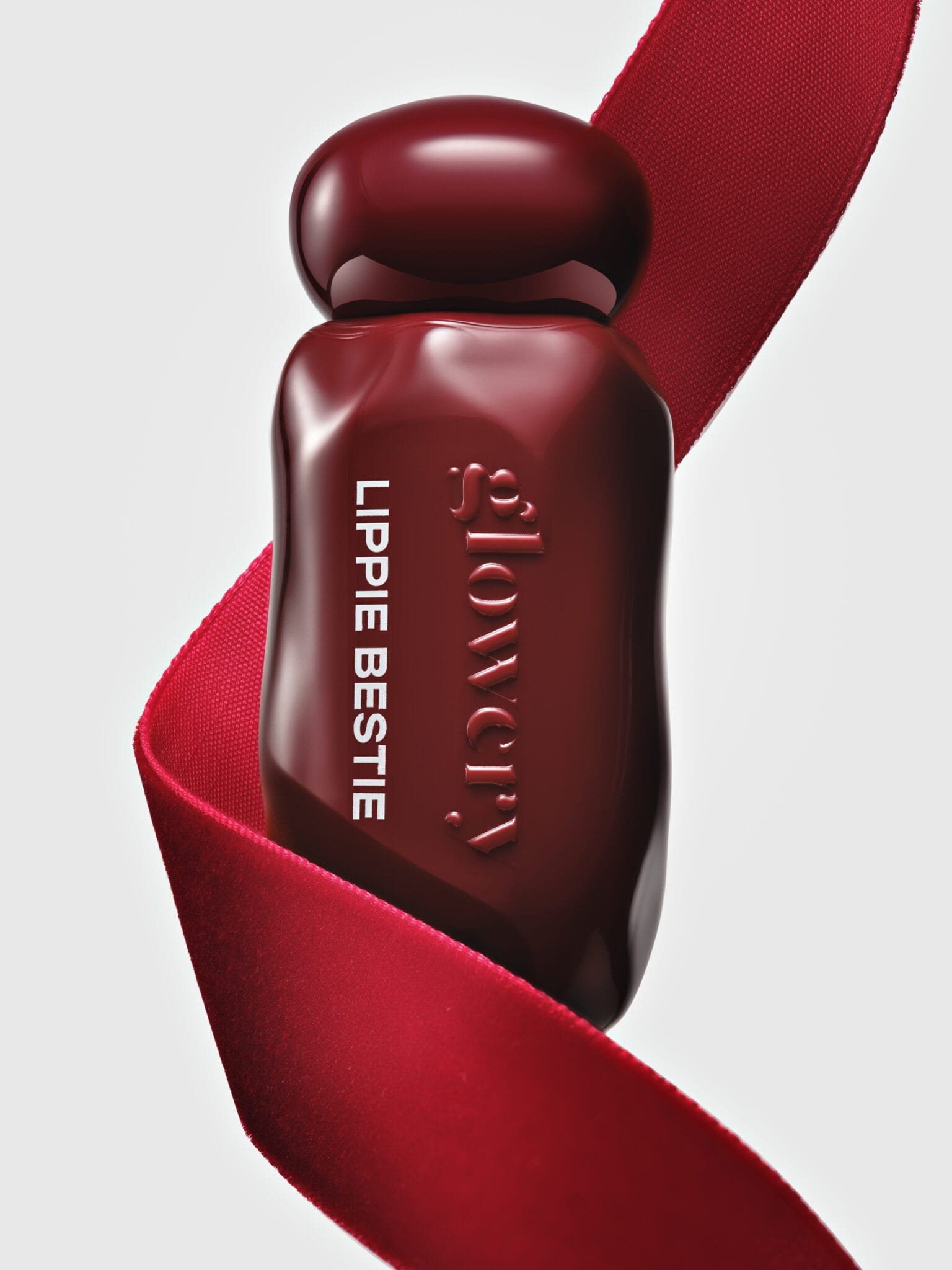 Glowery's mirror-shine lip oils product photo: cherry red and oxblood, glass, studio light, image 1 of 3