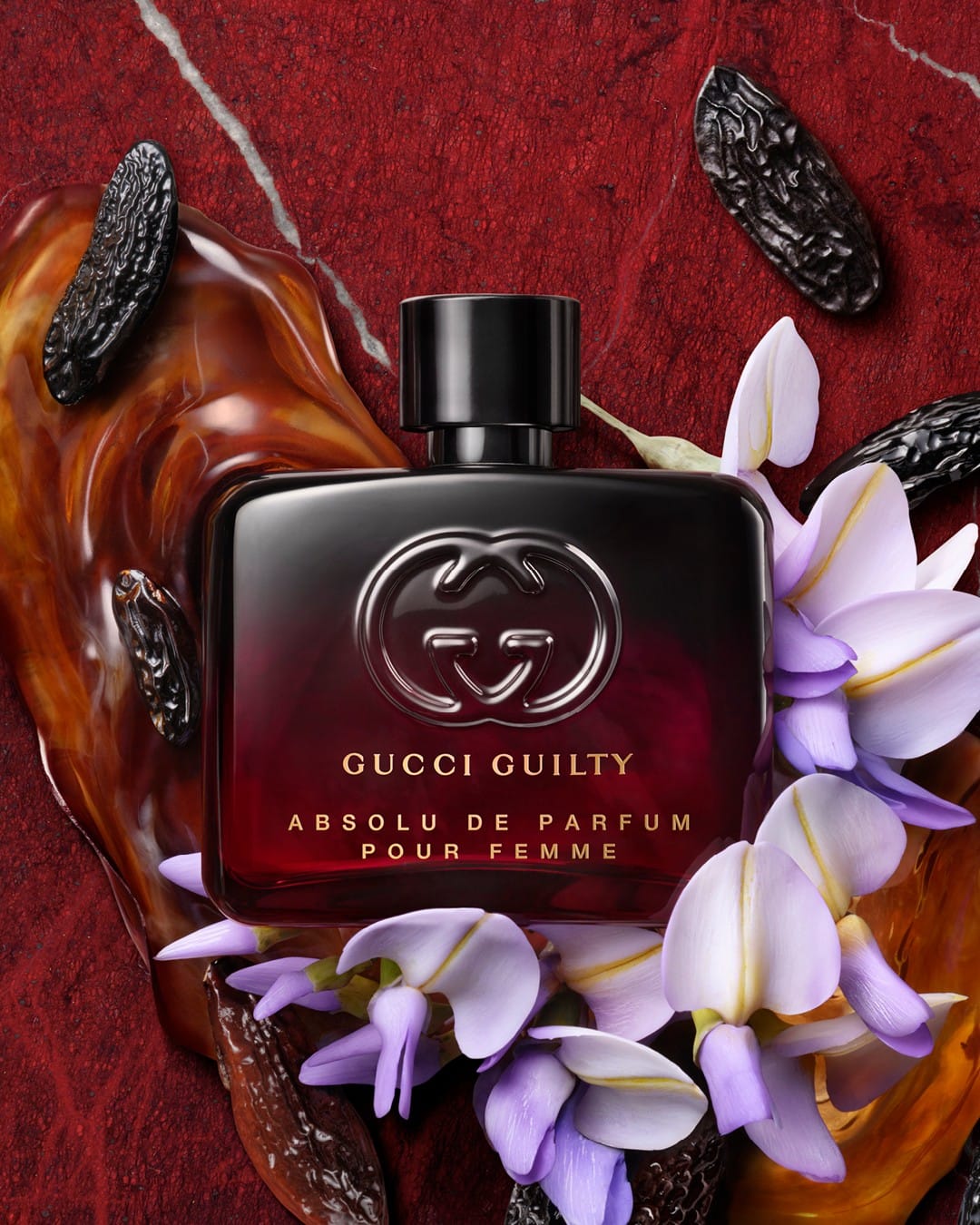 Gucci Guilty Absolu product photo: black glass, ruby red and amber, glass and stone, studio light, image 1 of 4
