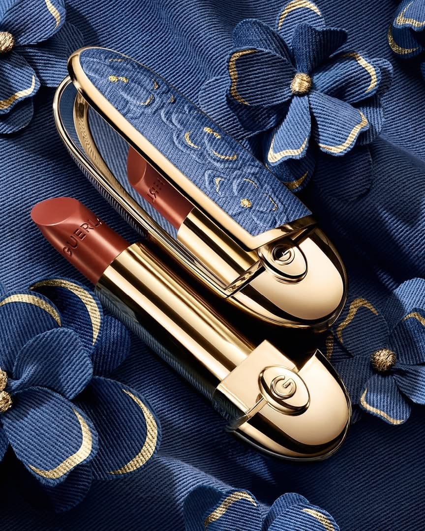 Guerlain Blooming Denim product photo: denim blue, polished gold and rosewood, metal, studio light, image 1 of 3