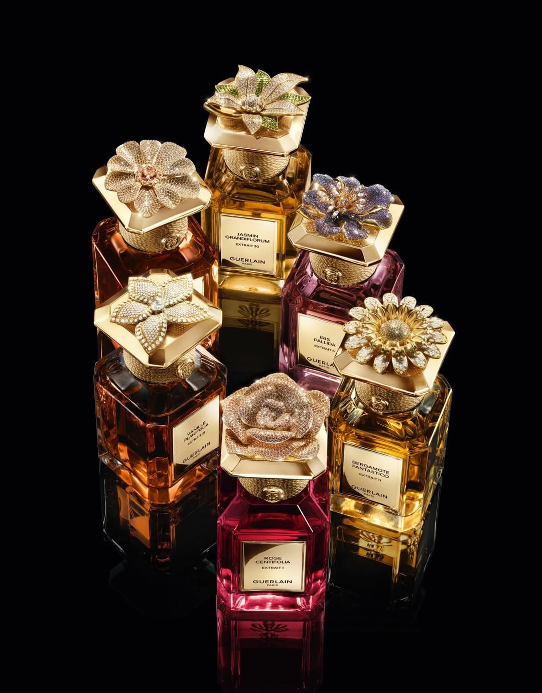 Guerlain fragrance photography product photo: polished gold, amber and magenta, glass, dramatic light