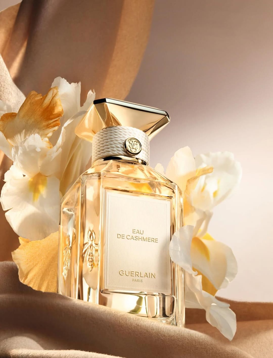 Guerlain fragrance photography product photo: champagne gold, blush pink, cream and pale green, glass, soft light, image 1 of 6