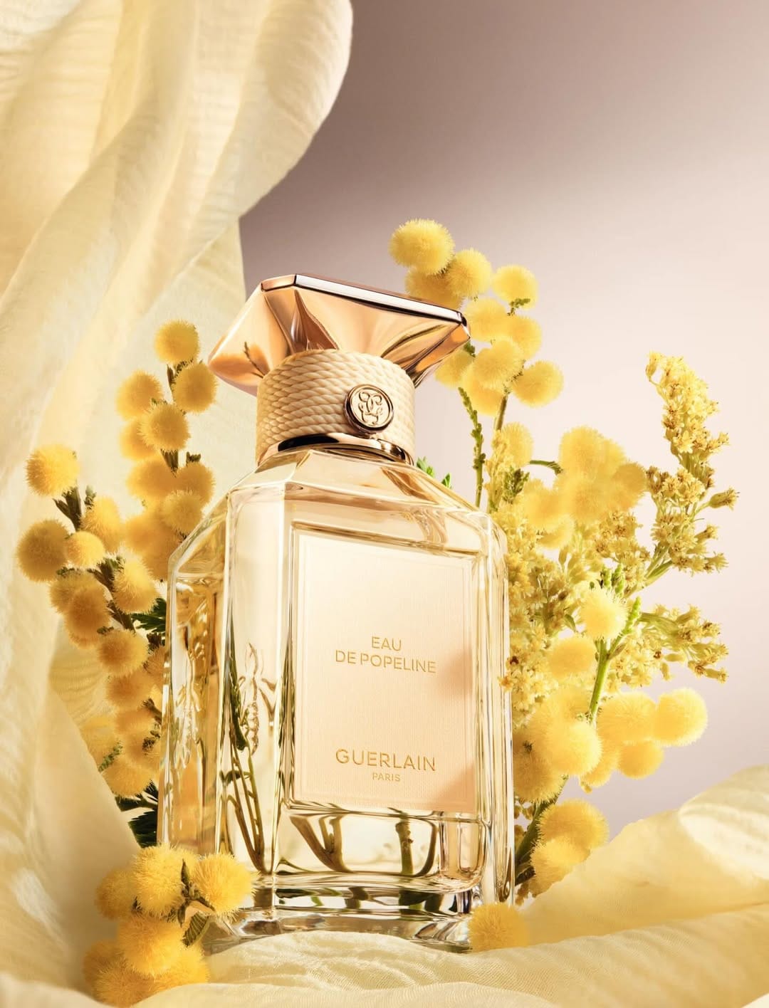 Guerlain fragrance photography product photo: champagne gold, blush pink, cream and pale green, glass, soft light, image 2 of 6
