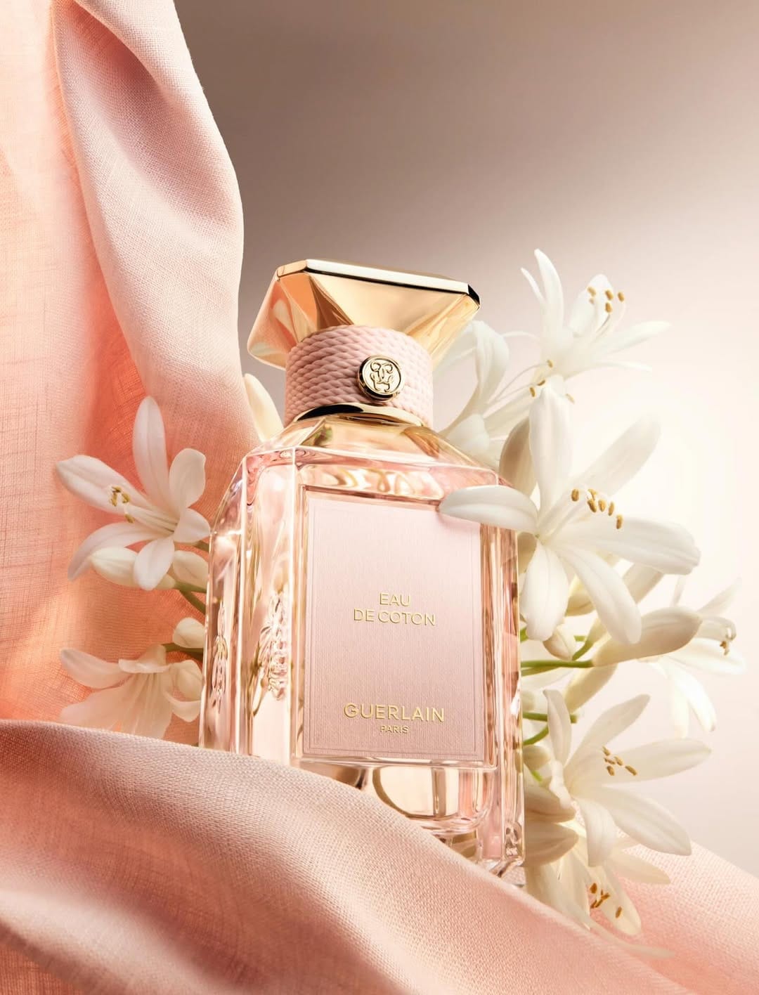 Guerlain fragrance photography product photo: champagne gold, blush pink, cream and pale green, glass, soft light, image 4 of 6