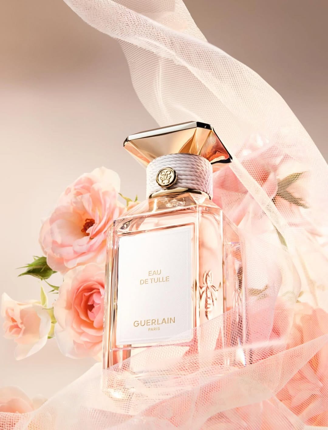 Guerlain fragrance photography product photo: champagne gold, blush pink, cream and pale green, glass, soft light, image 5 of 6