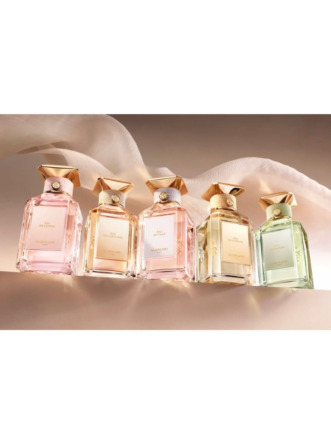 Guerlain fragrance photography product photo: champagne gold, blush pink, cream and pale green, glass, soft light, image 6 of 6