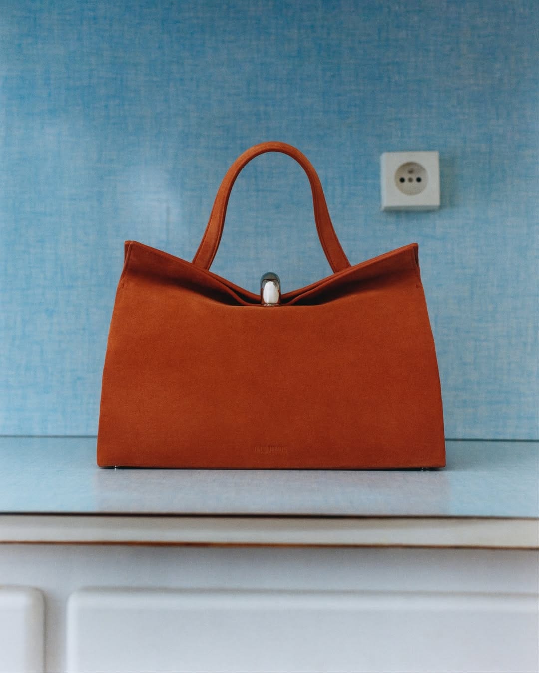 Jacquemus Le Paysan product photo: rust and mustard, fabric, natural light, image 1 of 4