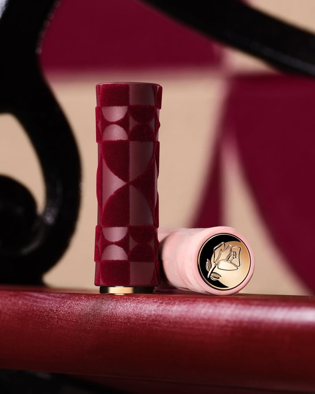 Lancôme L'Absolu Rouge Drama Matte product photo: burgundy velvet, blush pink and gold, fabric, studio light