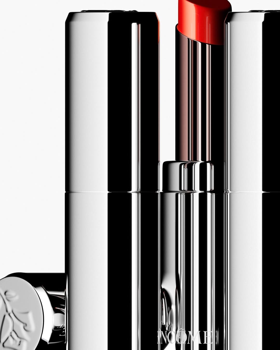 Lancôme lip balm product photo: chrome silver, black and lipstick red, metal, studio light, image 2 of 3