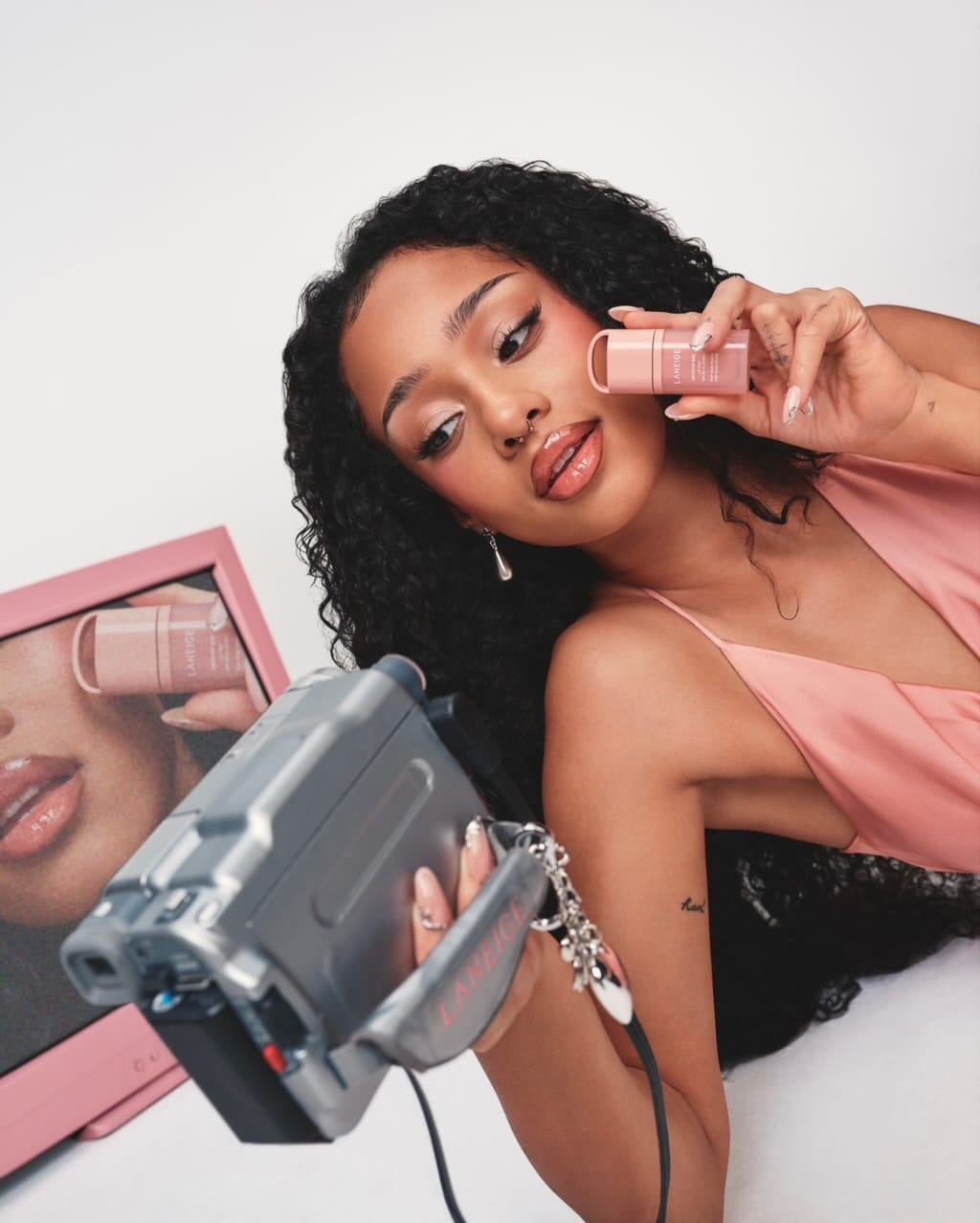 LANEIGE lip tint product photo: rosy pink and coral red, skin, soft light, image 6 of 7