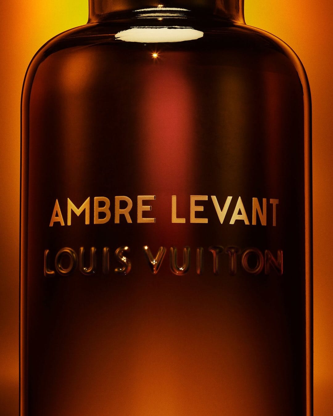 Louis Vuitton Ambre Levant product photo: dark amber, smoked black and gold lettering, glass, dramatic light, image 1 of 3