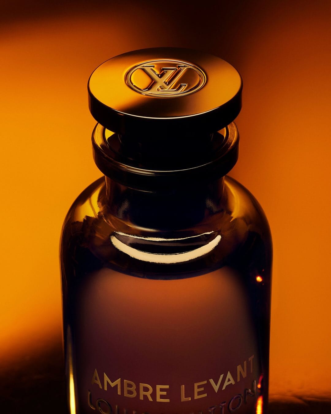 Louis Vuitton Ambre Levant product photo: dark amber, smoked black and gold lettering, glass, dramatic light, image 2 of 3