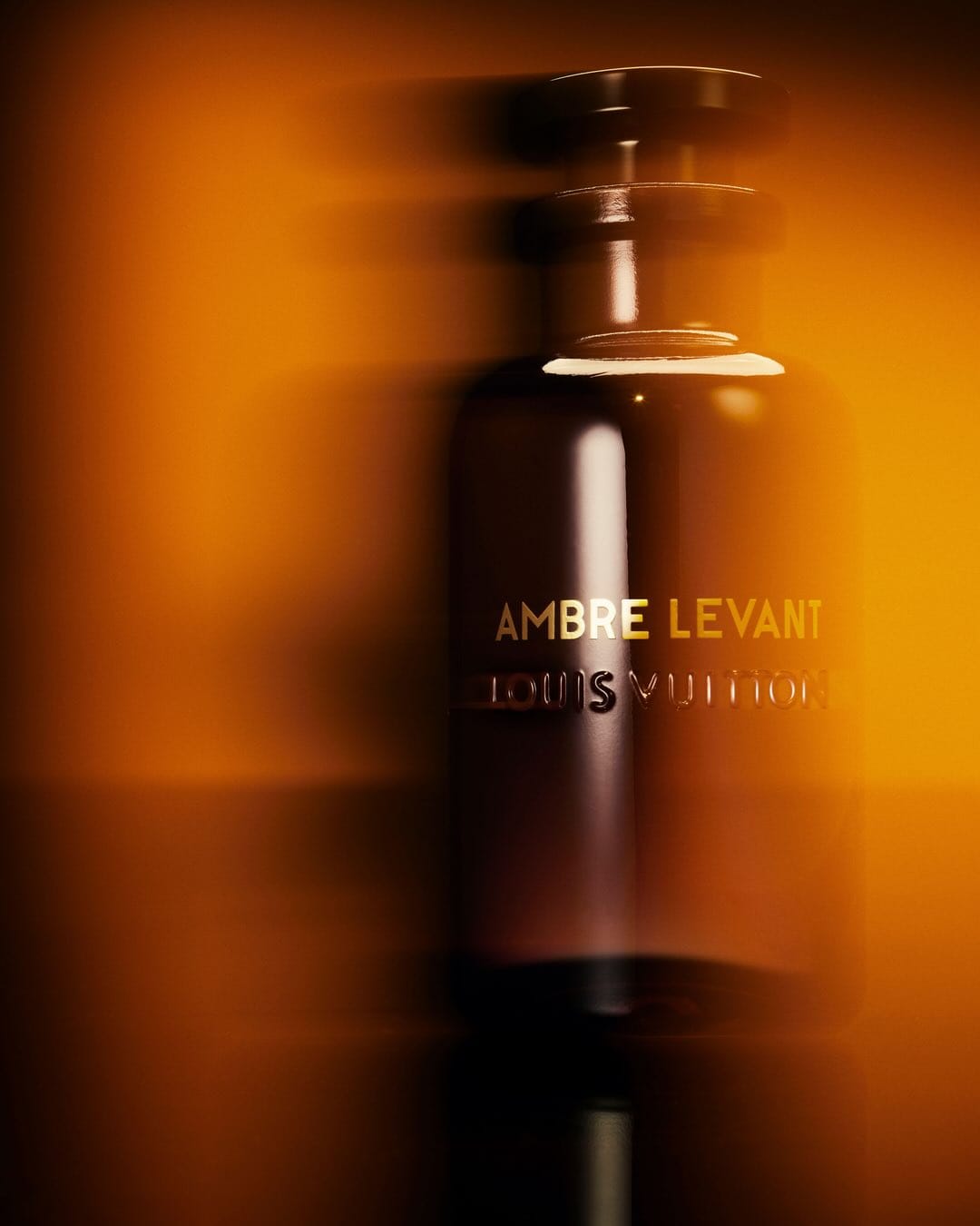 Louis Vuitton Ambre Levant product photo: dark amber, smoked black and gold lettering, glass, dramatic light, image 3 of 3