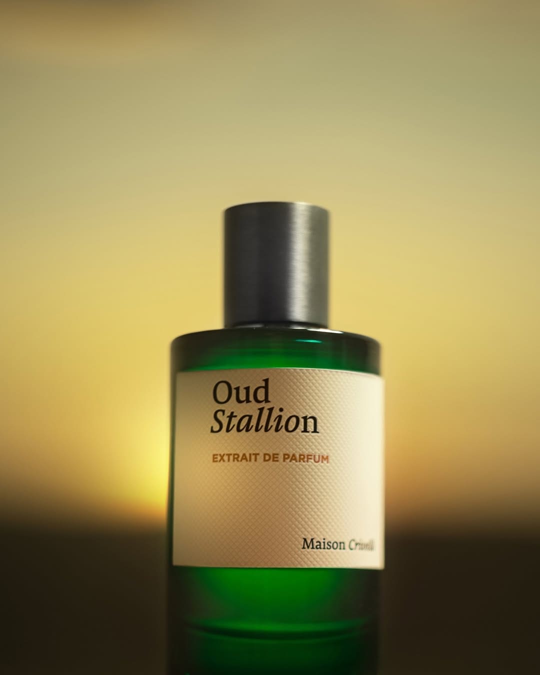 Maison Crivelli Oud Maracujá product photo: cobalt blue, emerald green, violet and cream label, sand, soft light, image 3 of 6