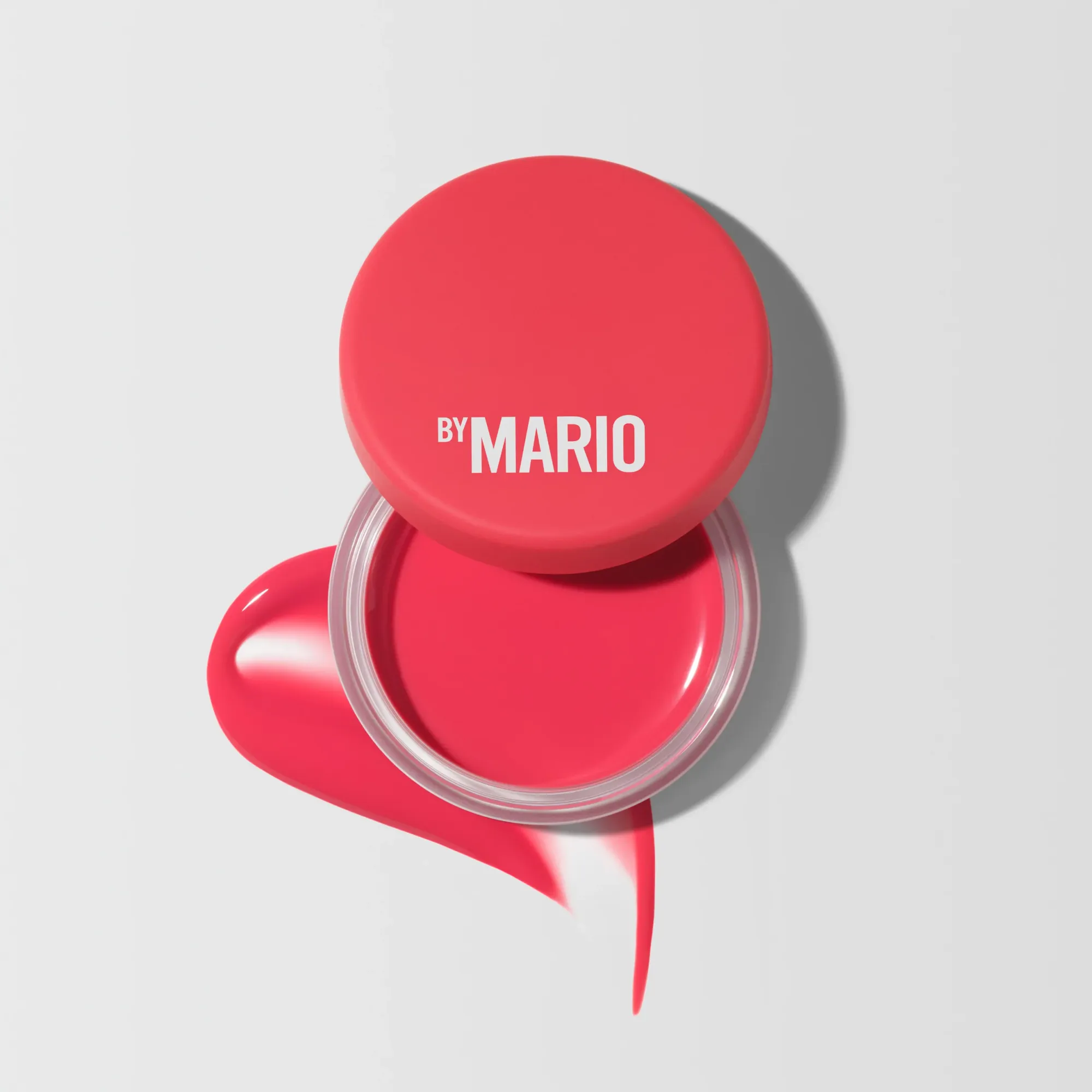 Makeup by Mario's jelly balm product photo: coral pink and cherry red, glass, soft light, image 1 of 8