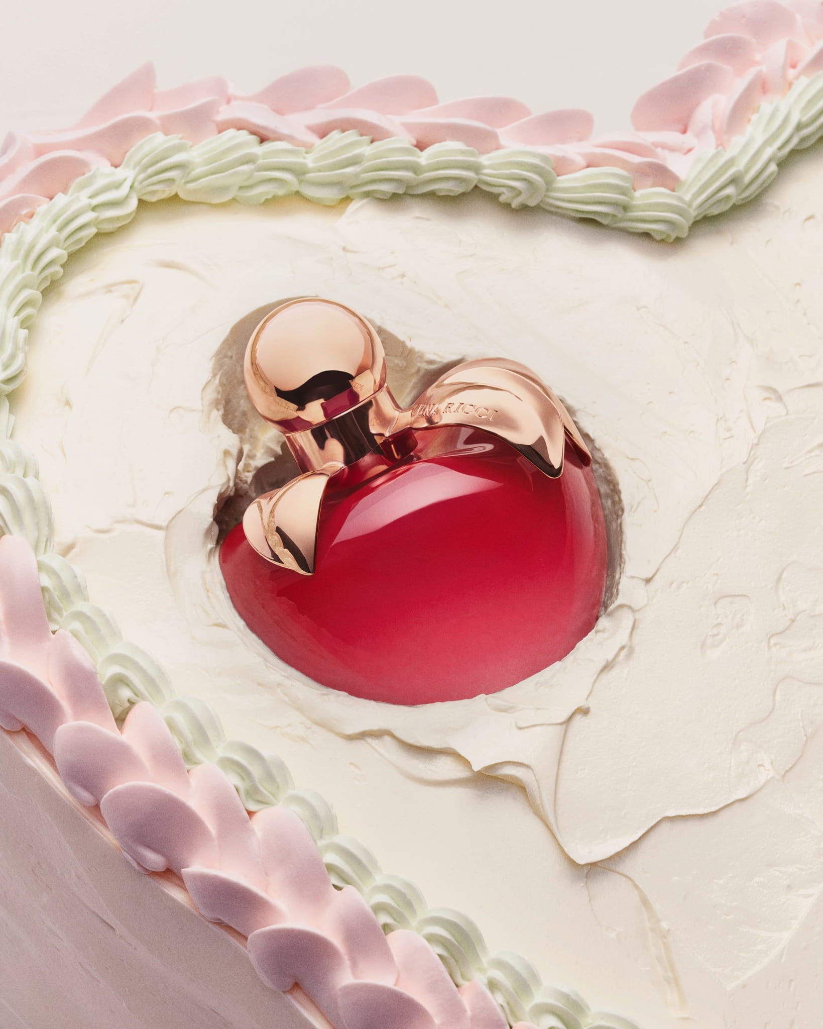 Nina Ricci's anniversary parfum product photo: ruby red, rose gold and blush pink, metal, soft light, image 4 of 5