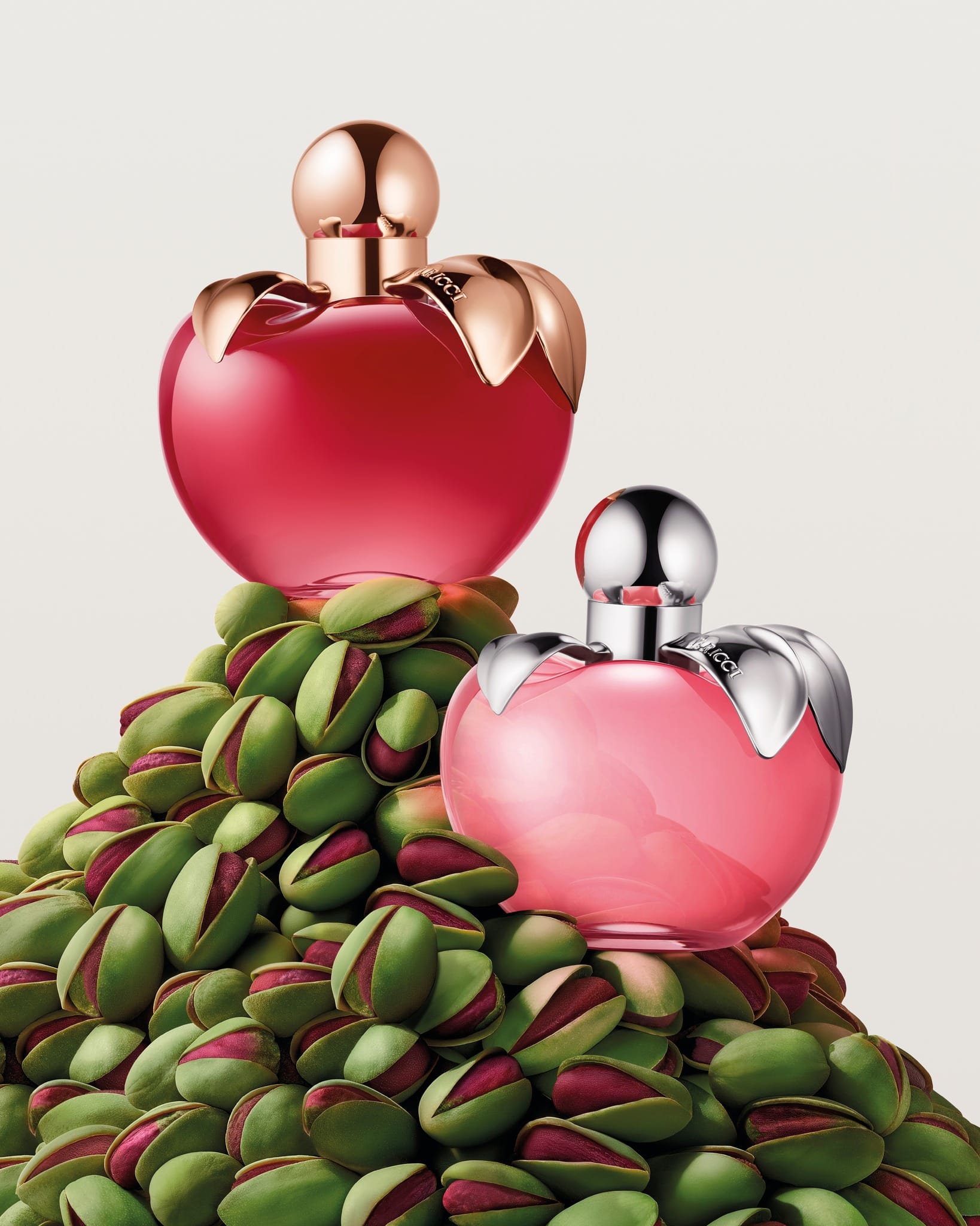 Nina Ricci's anniversary parfum product photo: ruby red, rose gold and blush pink, metal, soft light, image 5 of 5