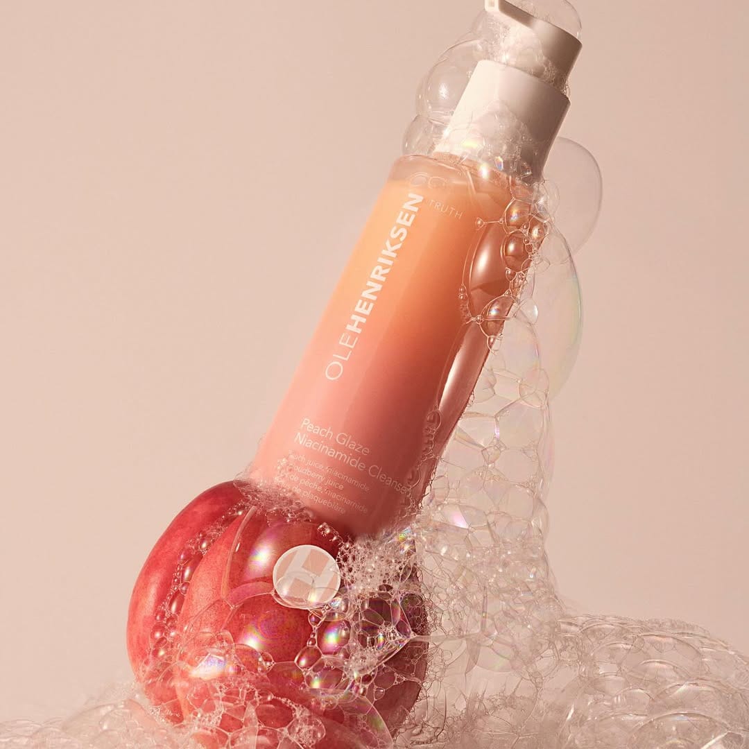 OLEHENRIKSEN Peach Glaze product photo: peach, coral pink and white, plastic and organic, soft light, image 1 of 4