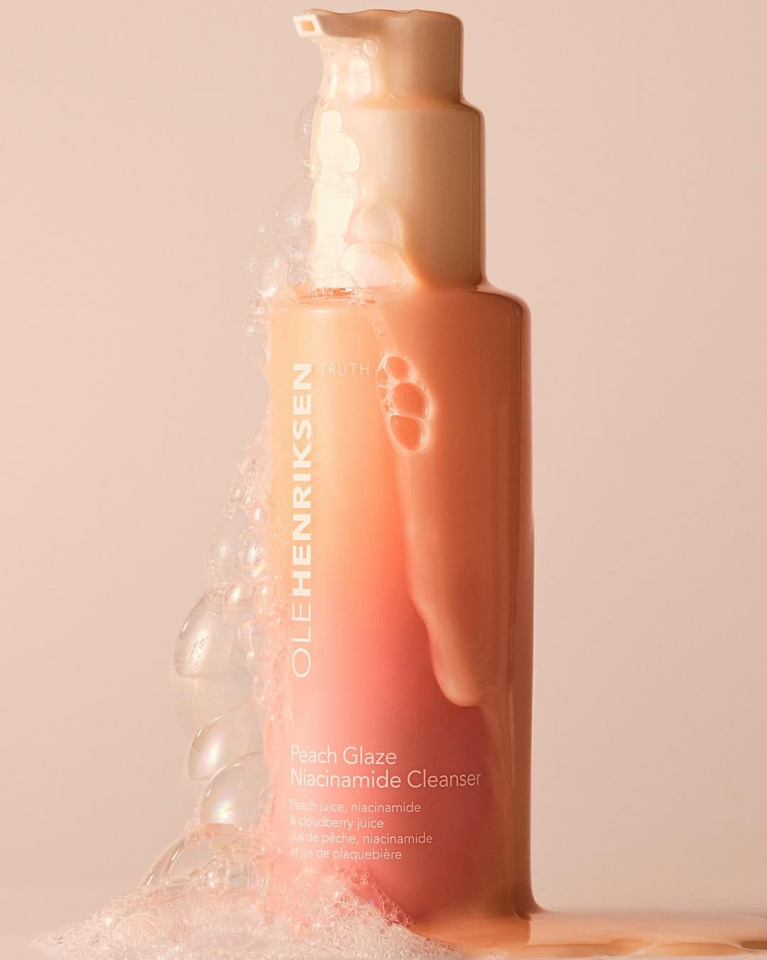 OLEHENRIKSEN Peach Glaze product photo: peach, coral pink and white, plastic and organic, soft light, image 3 of 4