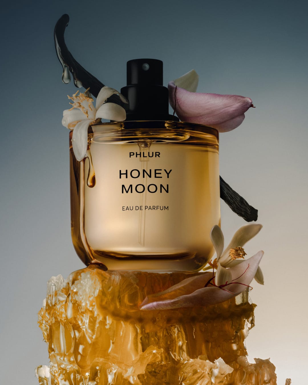 PHLUR's Honey Moon product photo: honey gold, cream white and black, glass and organic, dramatic light, image 1 of 2