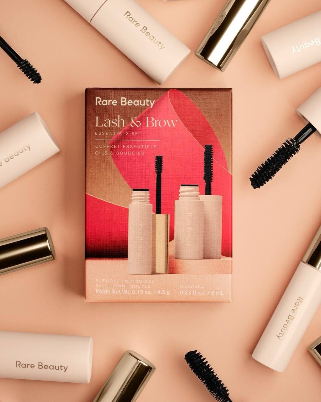Rare Beauty product photo: coral red, rose pink, cream and gold, paper, soft light, image 3 of 6