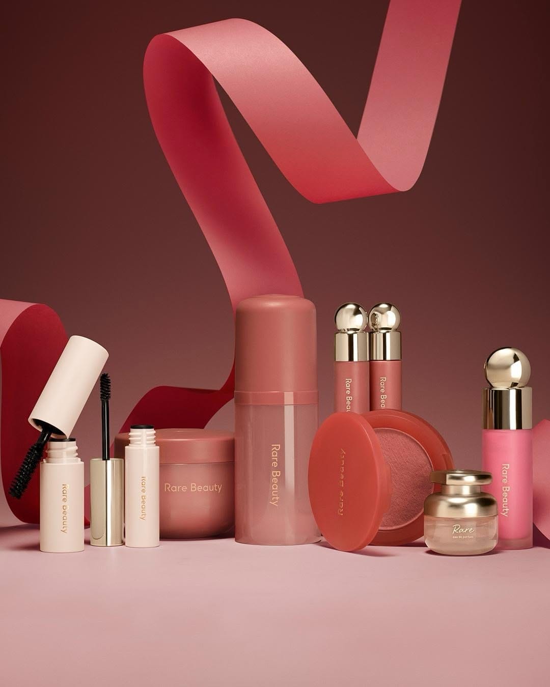 Rare Beauty product photo: coral red, rose pink, cream and gold, paper, soft light, image 6 of 6