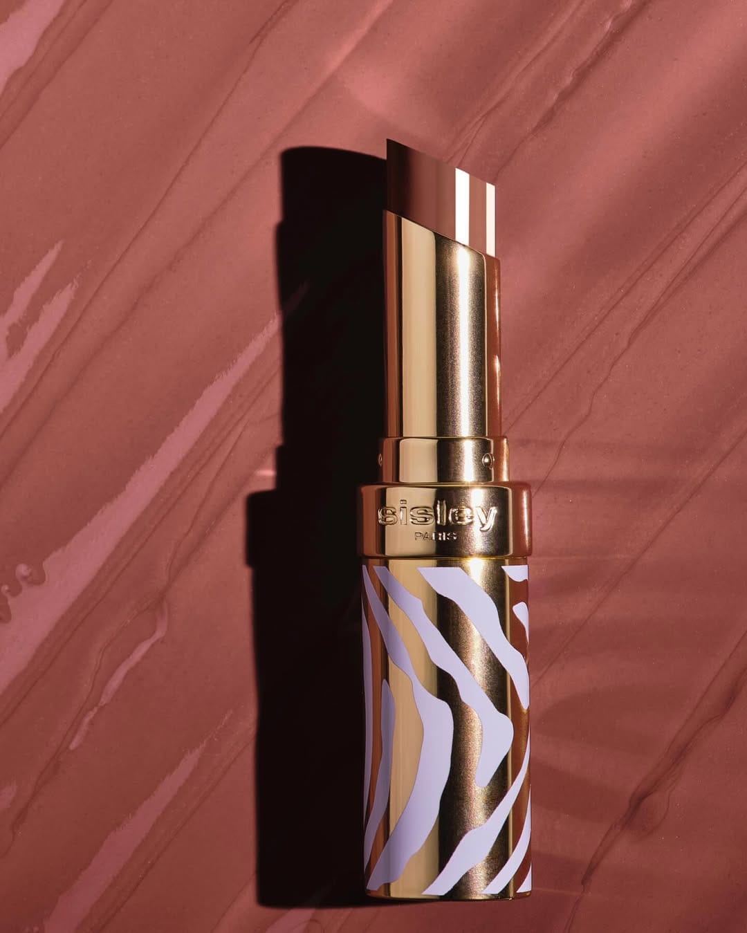 Sisley Paris lipstick product photo: gold, poppy red, chocolate brown and rosewood, metal, soft light, image 1 of 6
