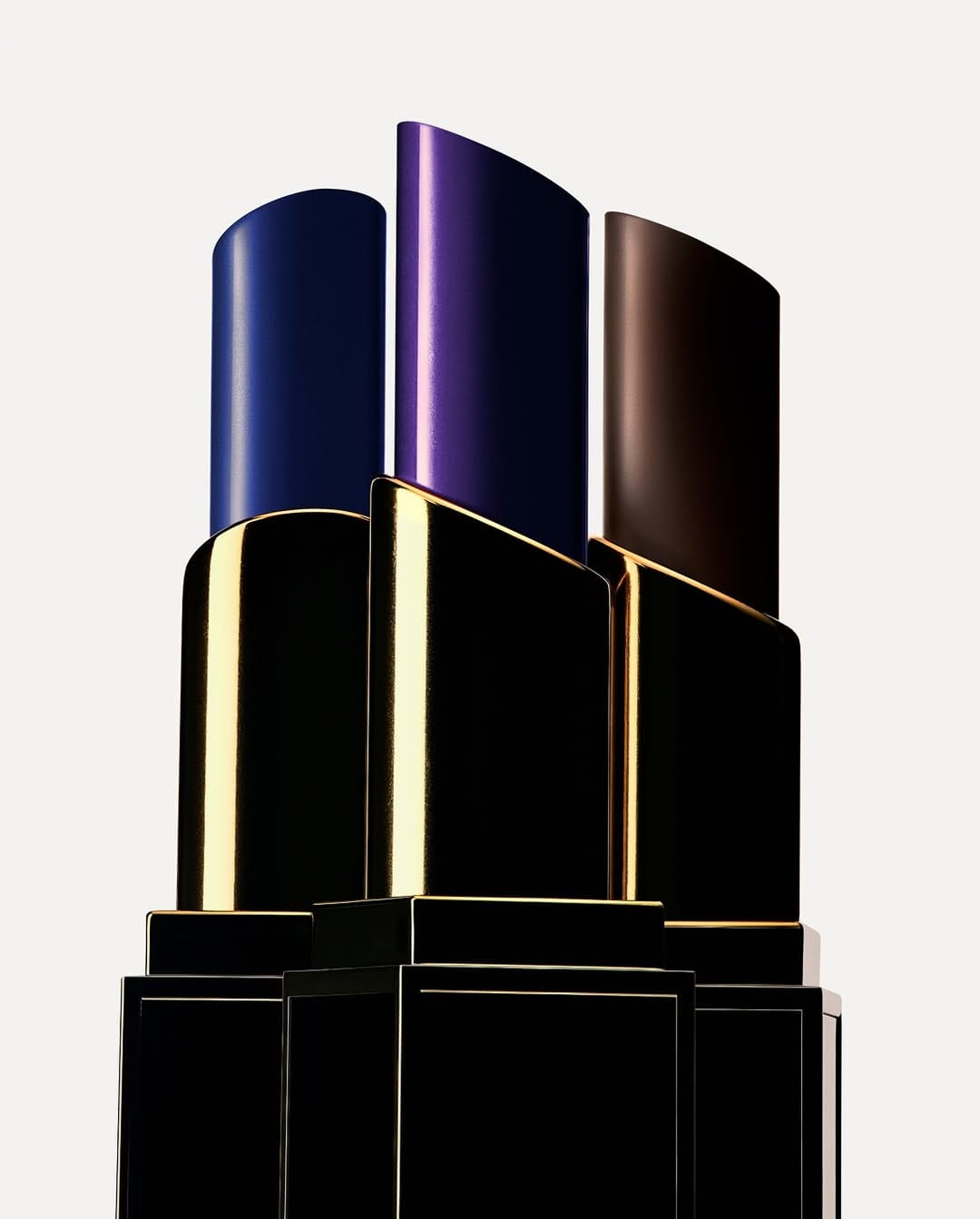 Tom Ford Beauty lipsticks product photo: black, violet, midnight blue and dark brown, skin, soft light, image 1 of 4
