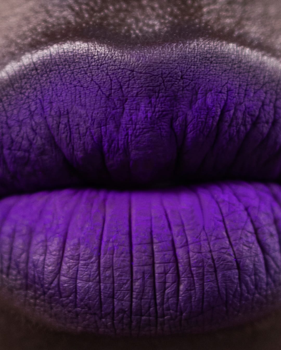 Tom Ford Beauty lipsticks product photo: black, violet, midnight blue and dark brown, skin, soft light, image 2 of 4
