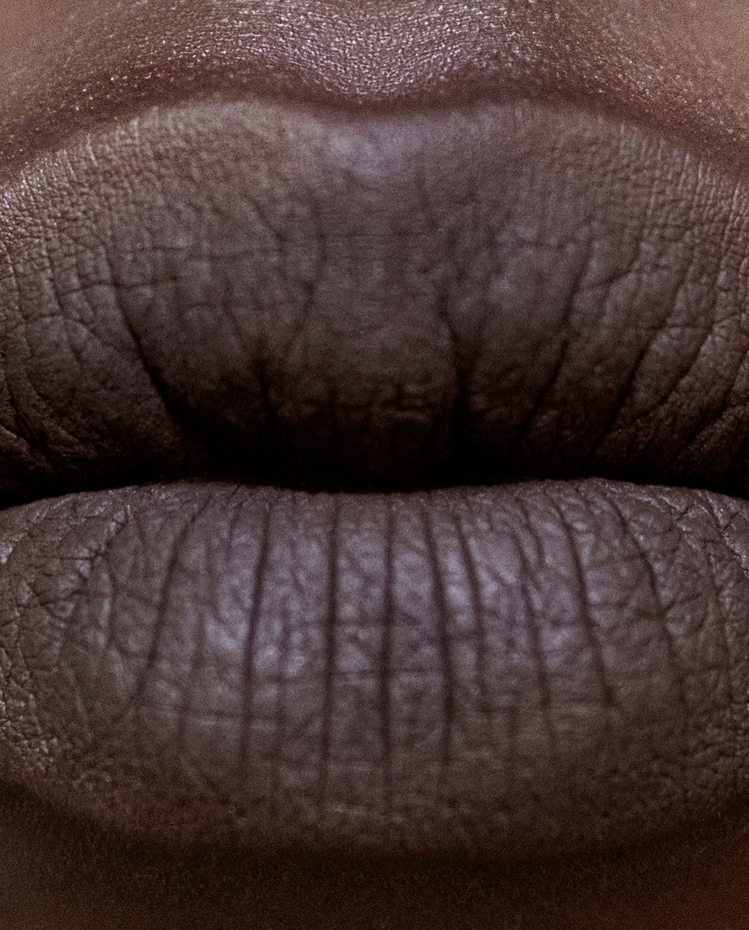 Tom Ford Beauty lipsticks product photo: black, violet, midnight blue and dark brown, skin, soft light, image 4 of 4