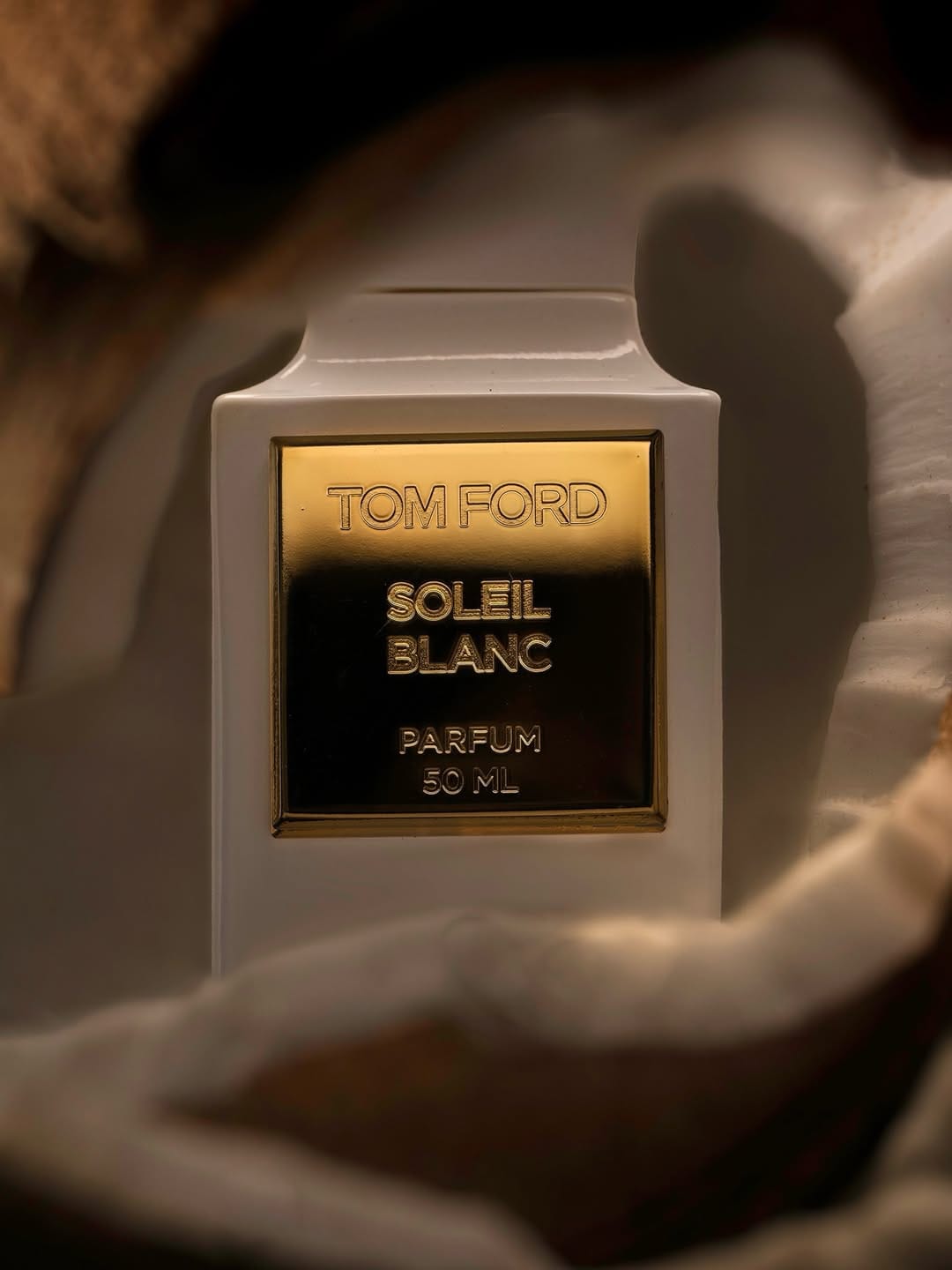 Tom Ford fragrance photography product photo: ivory white, brushed gold and espresso, glass and organic, dramatic light, image 8 of 9