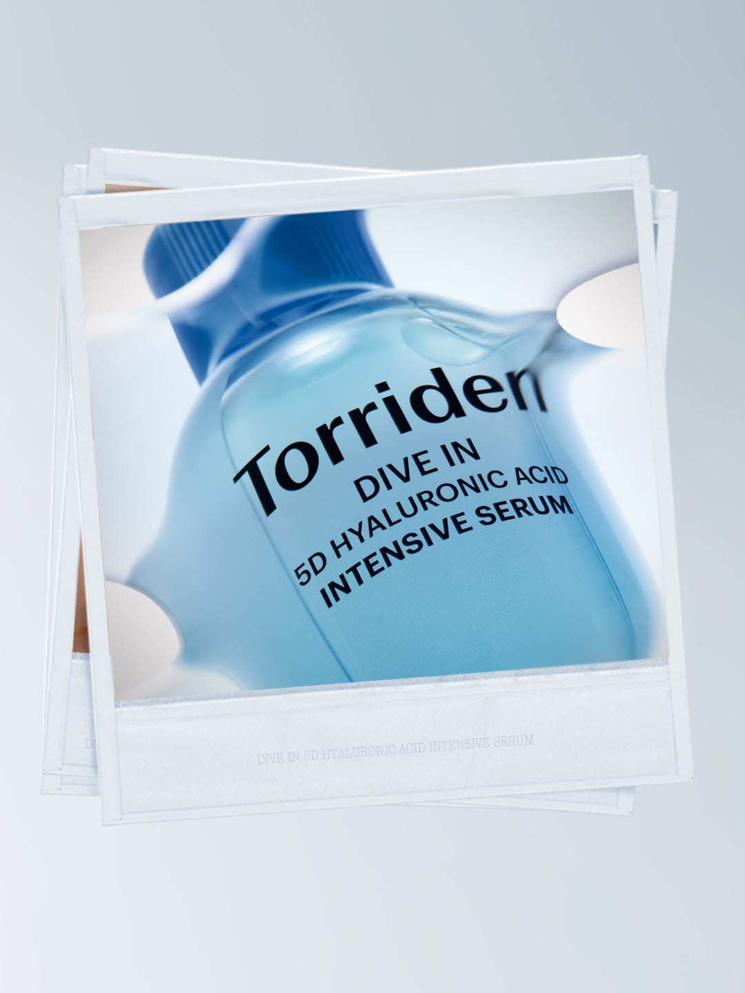 Torriden skincare product photo: hyaluronic blue and frosted clear, glass, soft light, image 4 of 6