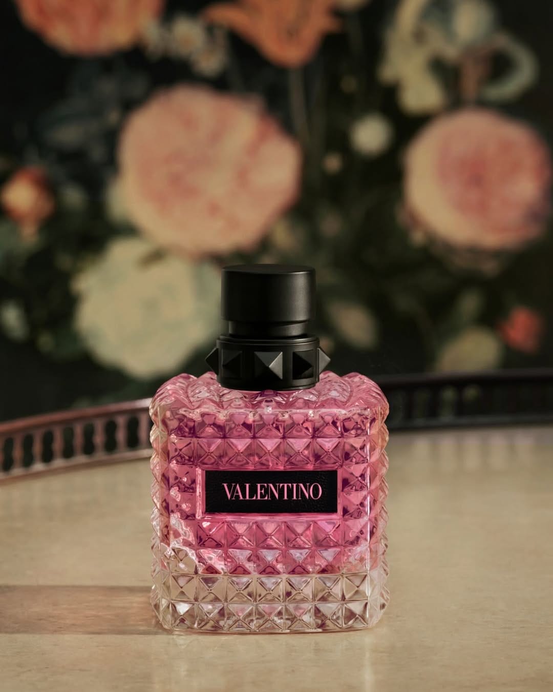 Valentino Beauty fragrance product photo: rose pink and black, glass, soft light