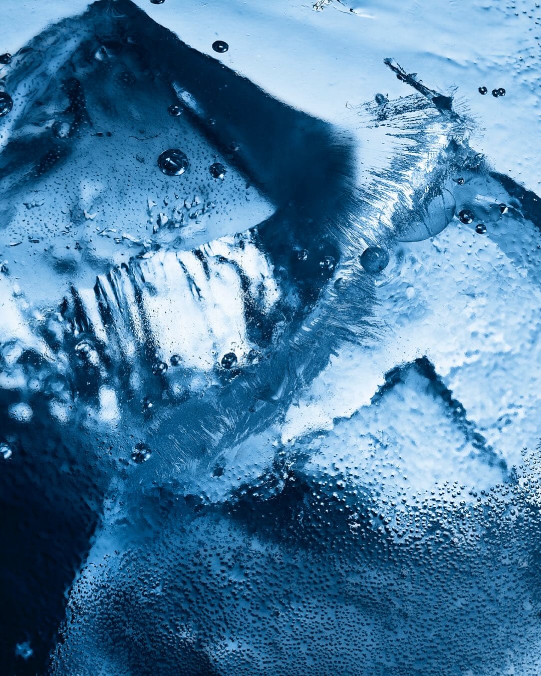 YSL Beauty Iced Cologne product photo: ice blue, black cap and silver label, organic, dramatic light, image 3 of 4